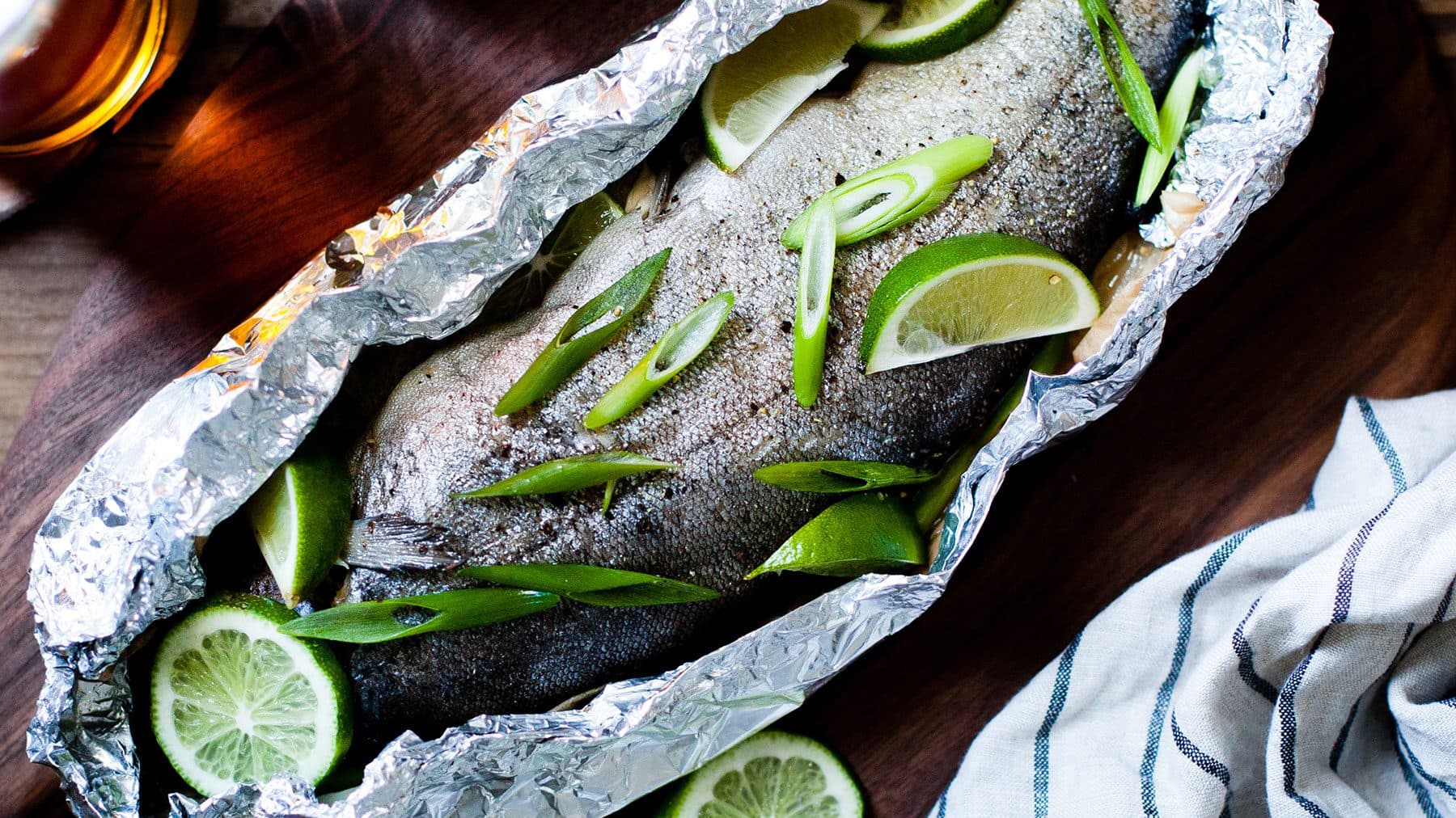 A cooked trout inside a foil packet