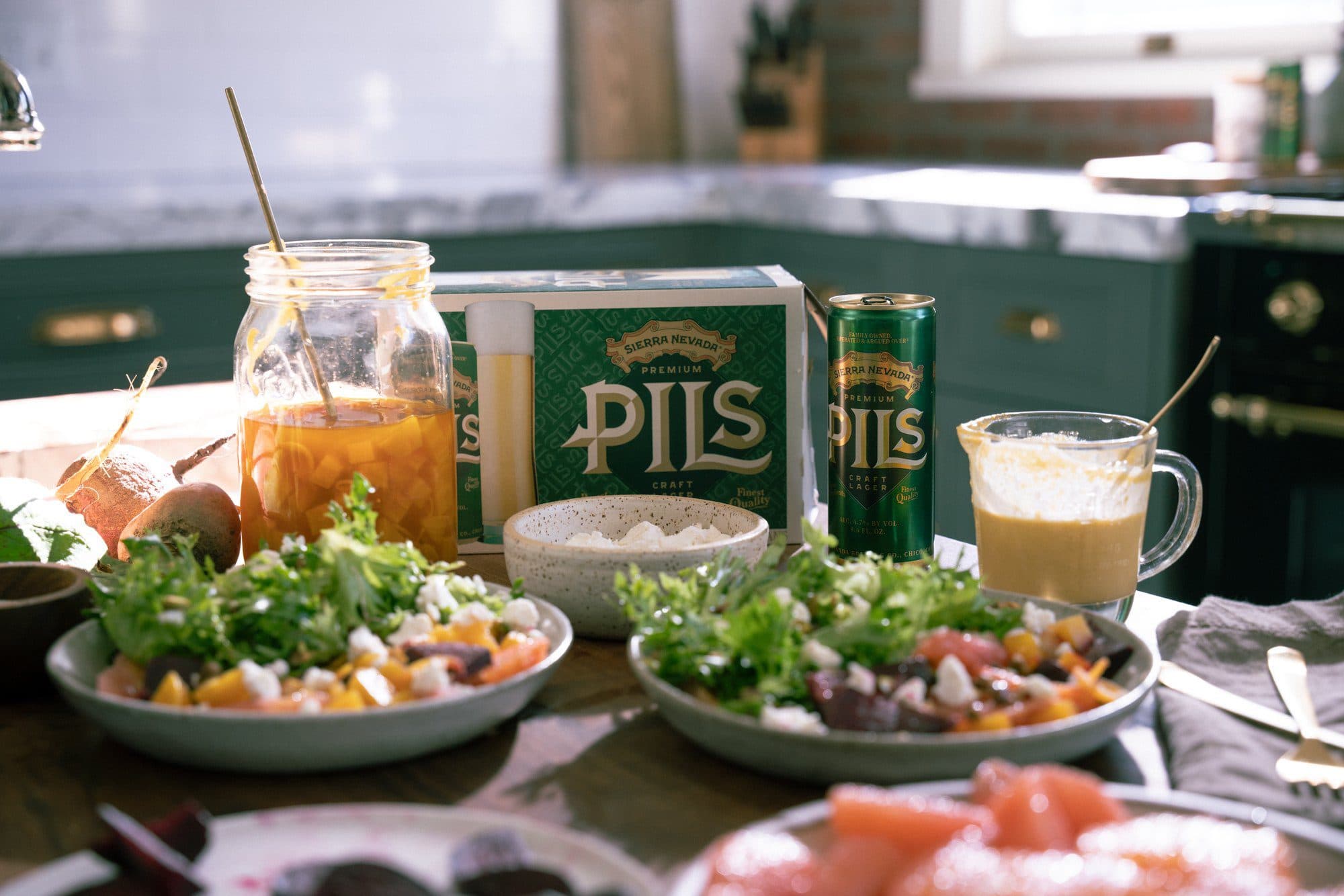 Sierra Nevada PILS on a table next to beet salad.